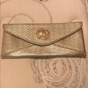 Lilly Pulitzer gold clutch with elephant clasp
